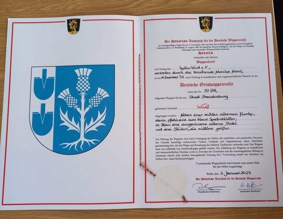 Diese Urkunde bestätigt die Eintragung des Wuster Ortsteilwappens in die Wappenrolle des Herold e.V..